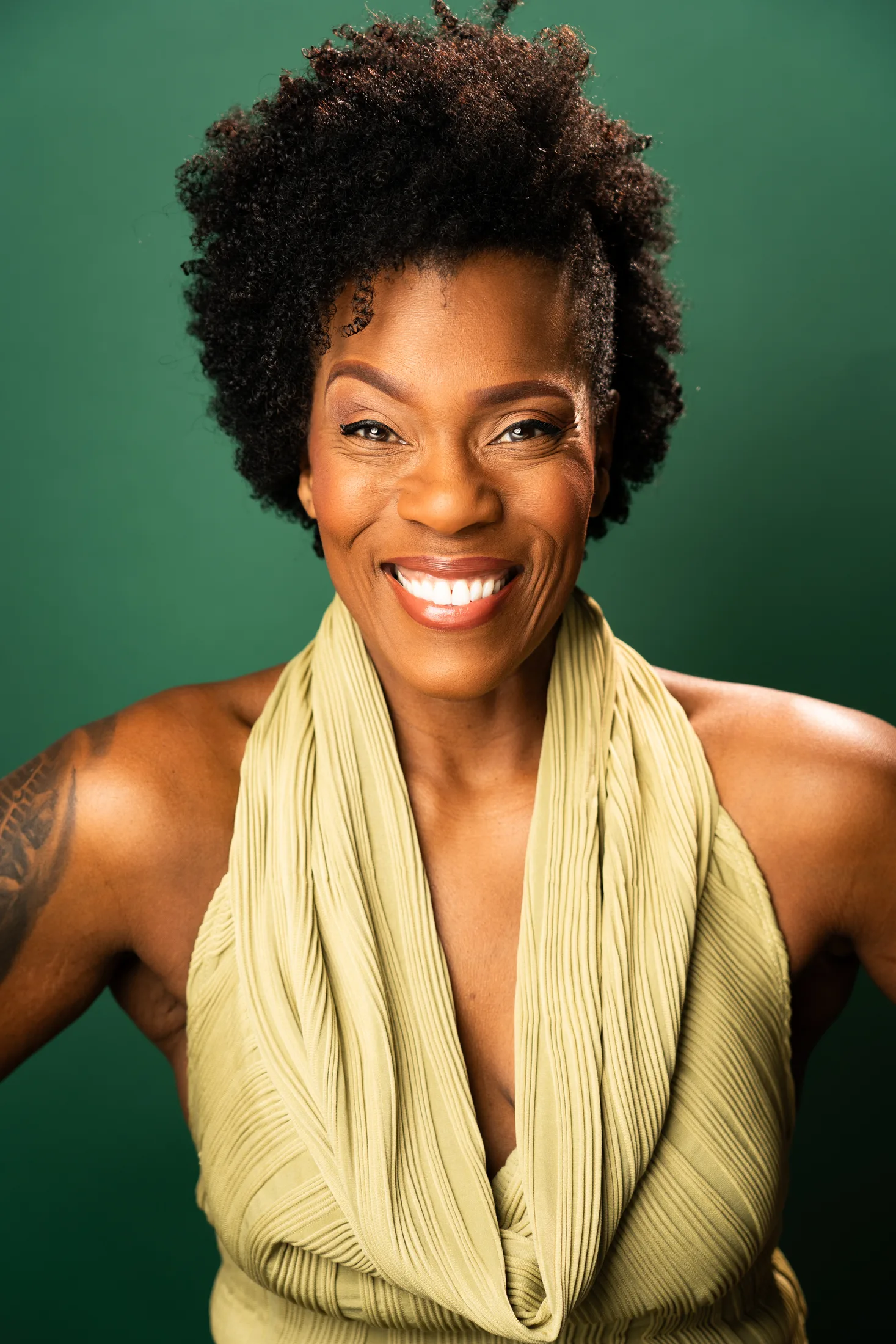 Patrece Bloomfield smiling against a green backdrop